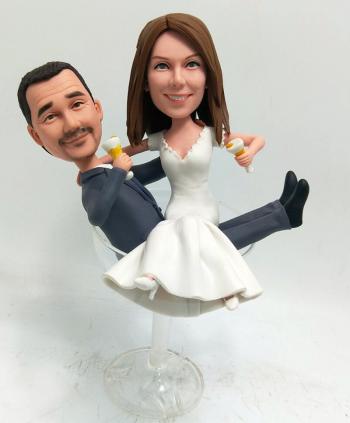 Custom bobblehead couple sitting on wine glass