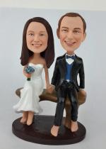 Custom wedding cake topper bobbleheads sitting on bench [AM1997]