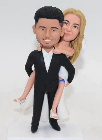 Custom groom carry bride bobblehead cake topper